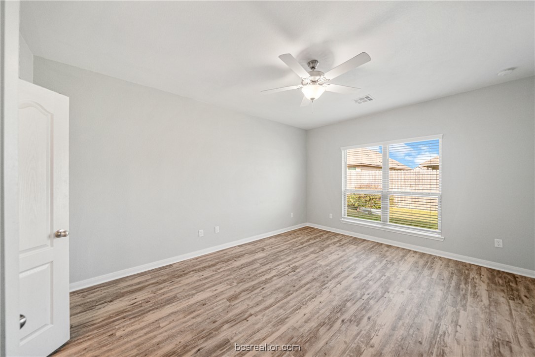 2018 Brisbane Way Bryan, TX 77807 - Photo 28 of 39 a view of an empty room with wooden floor and a window