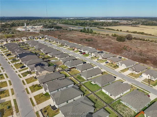 an aerial view of residential building and parking space