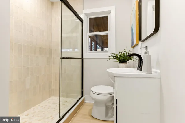 a bathroom with a toilet and a shower