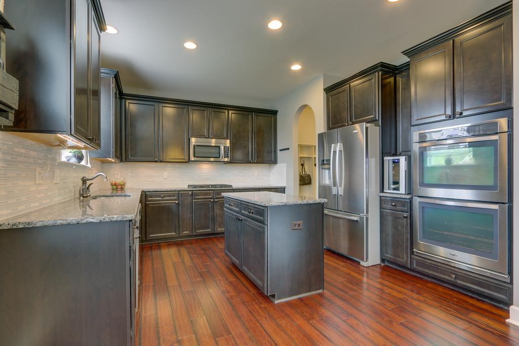 3005 Langston Place Spring Hill, TN 37174 - Photo 13 of 30 a kitchen with granite countertop a refrigerator and a sink