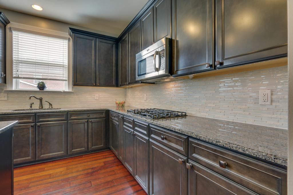 3005 Langston Place Spring Hill, TN 37174 - Photo 15 of 30 a kitchen with stainless steel appliances granite countertop a sink stove and cabinets