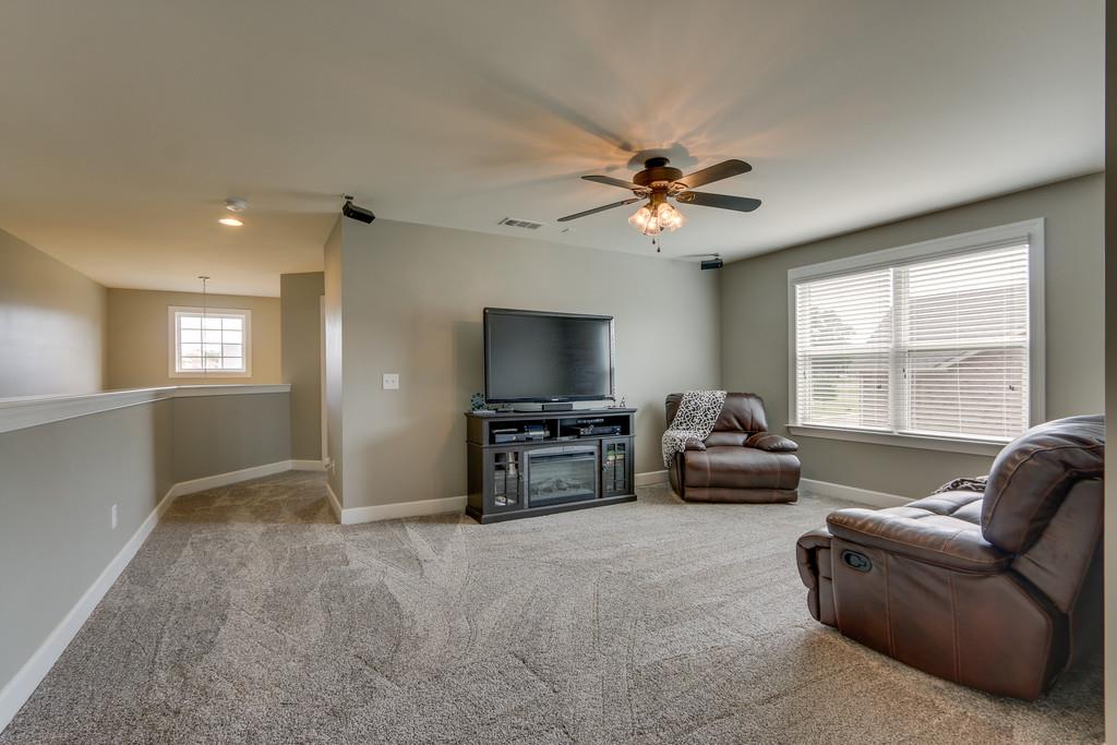 3005 Langston Place Spring Hill, TN 37174 - Photo 17 of 30 a living room with furniture and a flat screen tv
