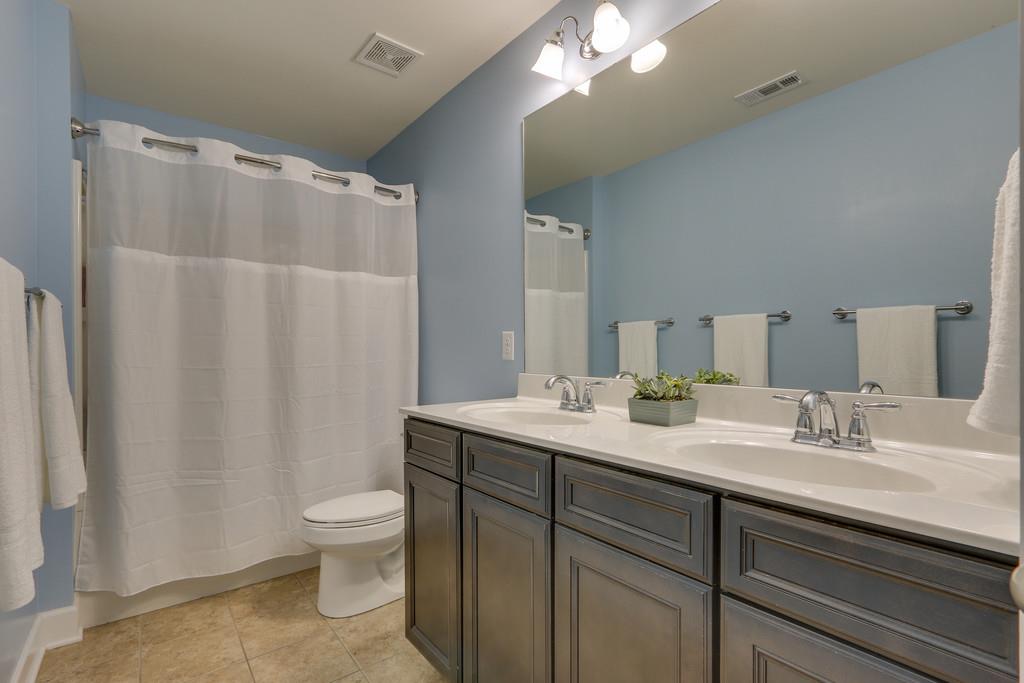 3005 Langston Place Spring Hill, TN 37174 - Photo 24 of 30 a bathroom with a double vanity sink toilet and a mirror