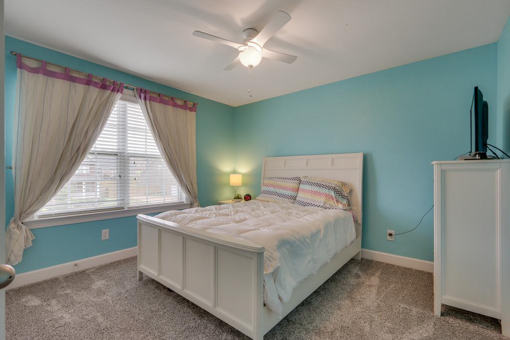 3005 Langston Place Spring Hill, TN 37174 - Photo 25 of 30 a bedroom with a bed and a large window