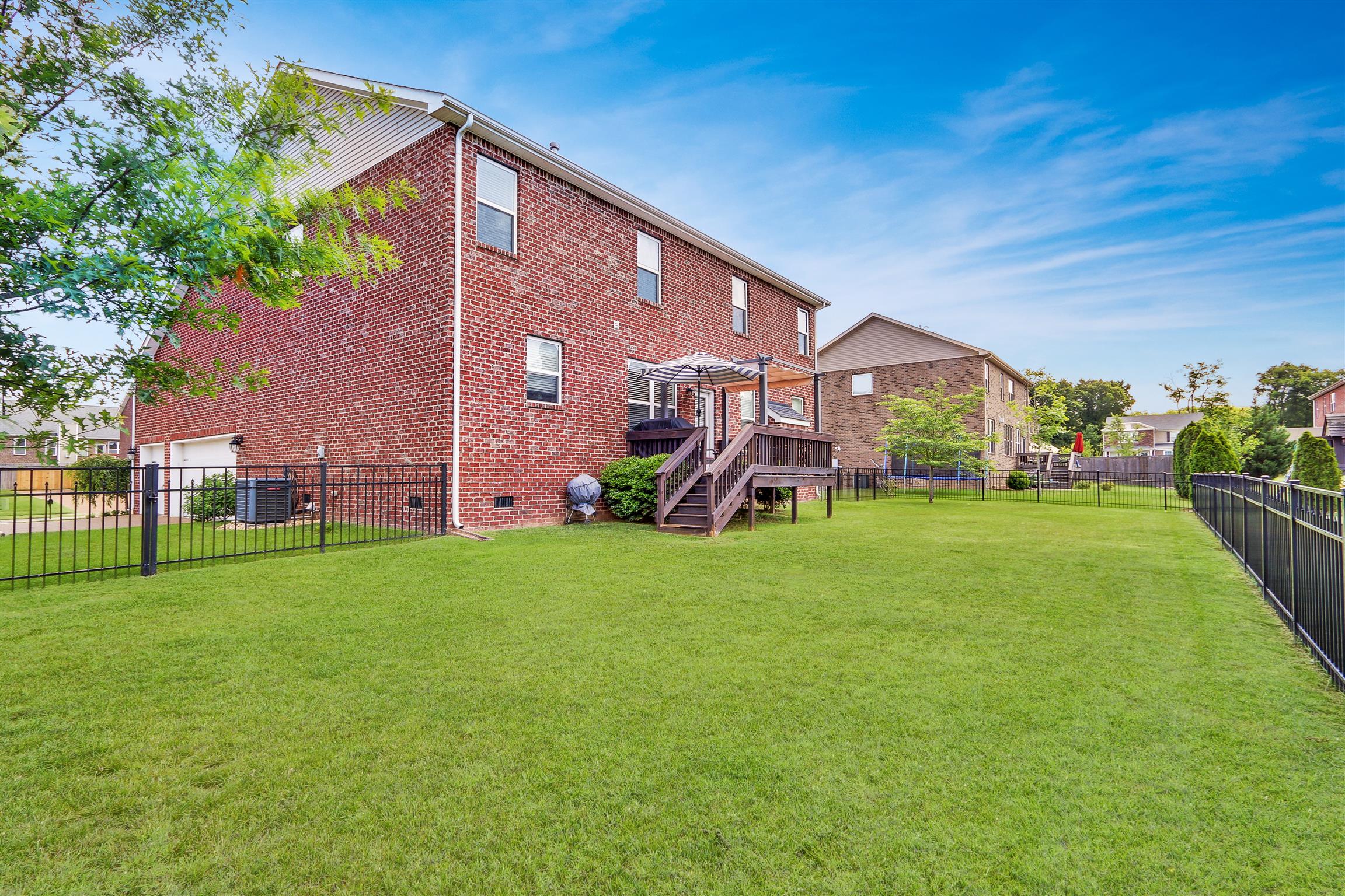 3005 Langston Place Spring Hill, TN 37174 - Photo 28 of 30 a view of a backyard with plants and a garden