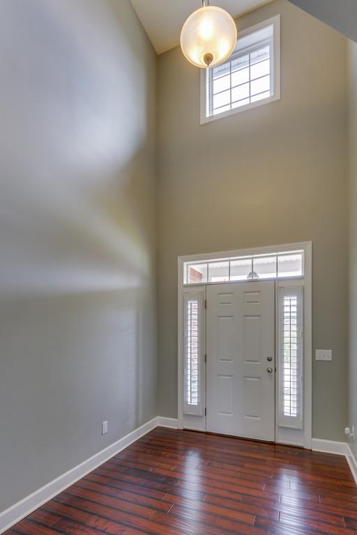 3005 Langston Place Spring Hill, TN 37174 - Photo 6 of 30 an empty room with wooden floor cabinet and windows
