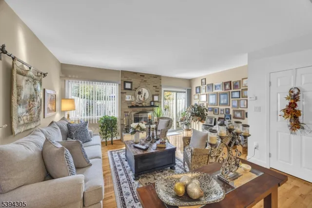 a view of a hallway with wooden floor and a bathroom