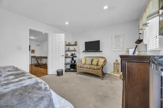 a bedroom with a bed and flat screen tv