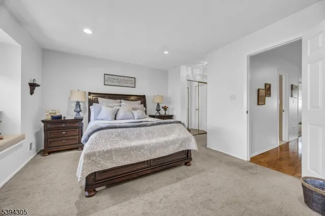 a bathroom with a granite countertop sink a toilet and a mirror