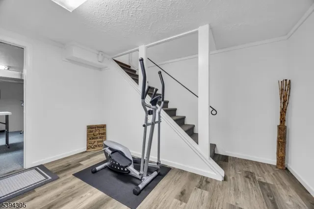 a view of a patio with a table and chairs under an umbrella