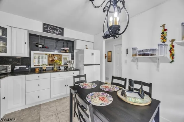 a kitchen with stainless steel appliances granite countertop a sink a stove a kitchen island with chairs and cabinets