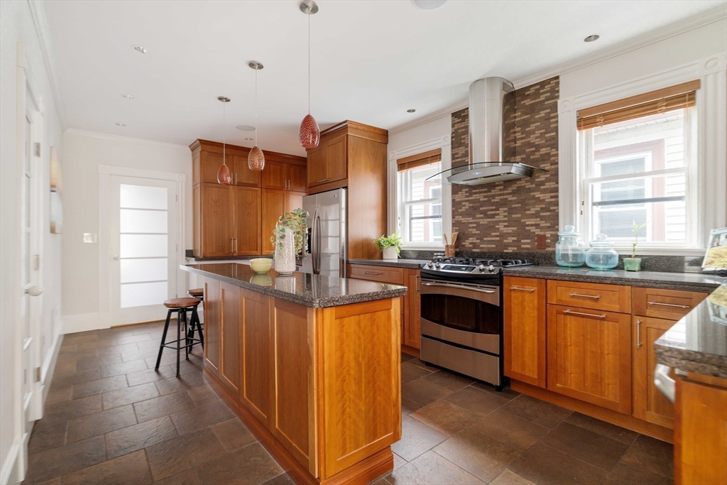18-20 Windom Street Somerville, MA 02144 - Photo 11 of 34 a kitchen with stainless steel appliances granite countertop a stove and a sink