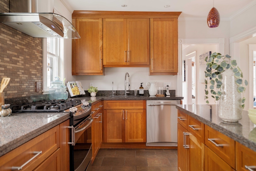 18-20 Windom Street Somerville, MA 02144 - Photo 12 of 34 a kitchen with stainless steel appliances a sink stove and cabinets