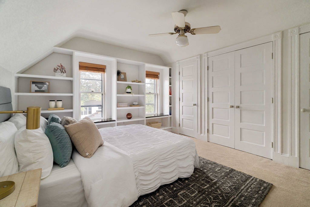 18-20 Windom Street Somerville, MA 02144 - Photo 18 of 34 a bedroom with a large bed a chandelier and closet