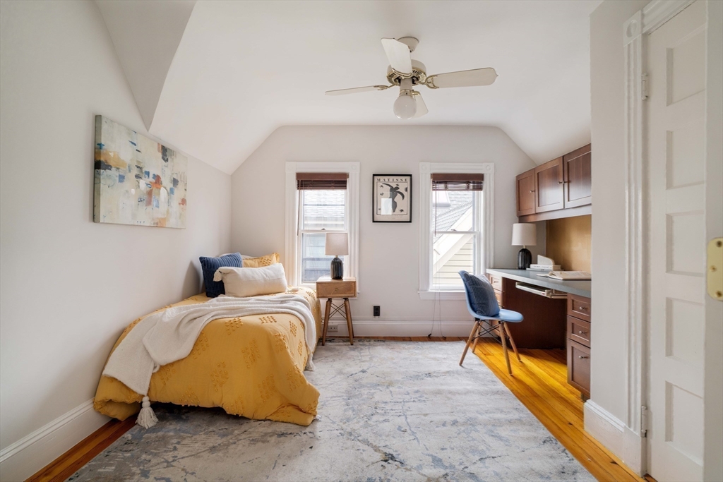 18-20 Windom Street Somerville, MA 02144 - Photo 19 of 34 a bedroom with a bed and a chandelier