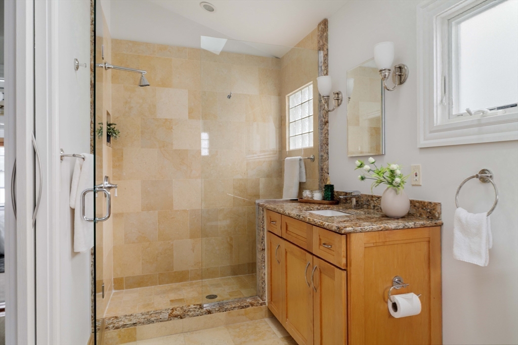 18-20 Windom Street Somerville, MA 02144 - Photo 21 of 34 a bathroom with a granite countertop shower a sink and a mirror
