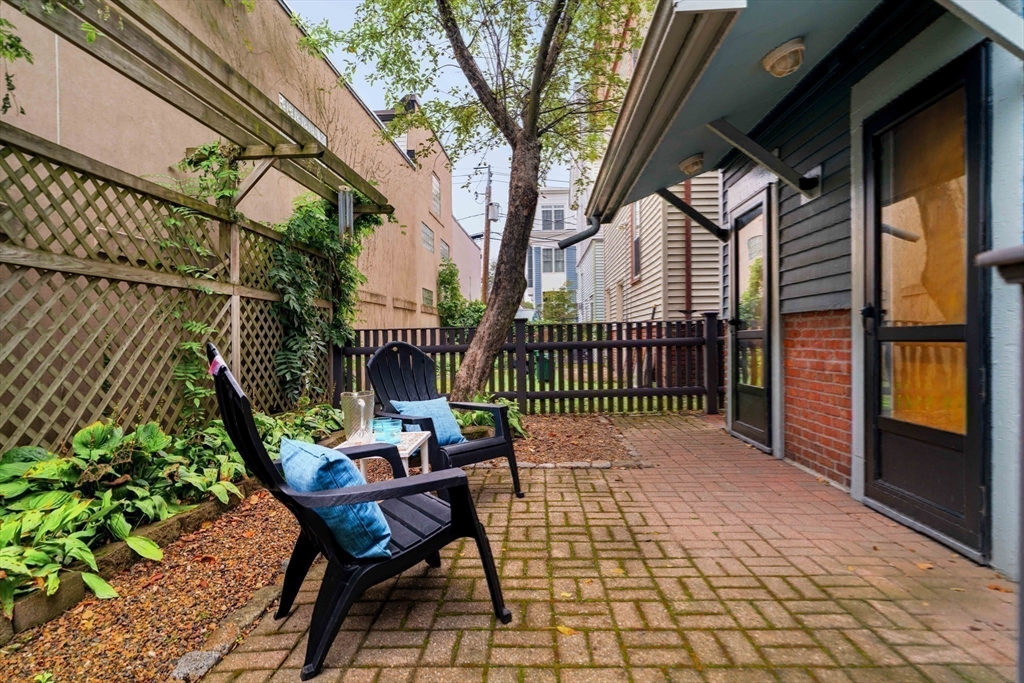18-20 Windom Street Somerville, MA 02144 - Photo 32 of 34 a backyard of a house with table and chairs
