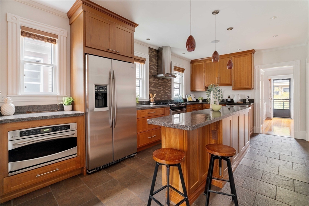 18-20 Windom Street Somerville, MA 02144 - Photo 9 of 34 a kitchen with stainless steel appliances a stove a sink refrigerator and a cabinets