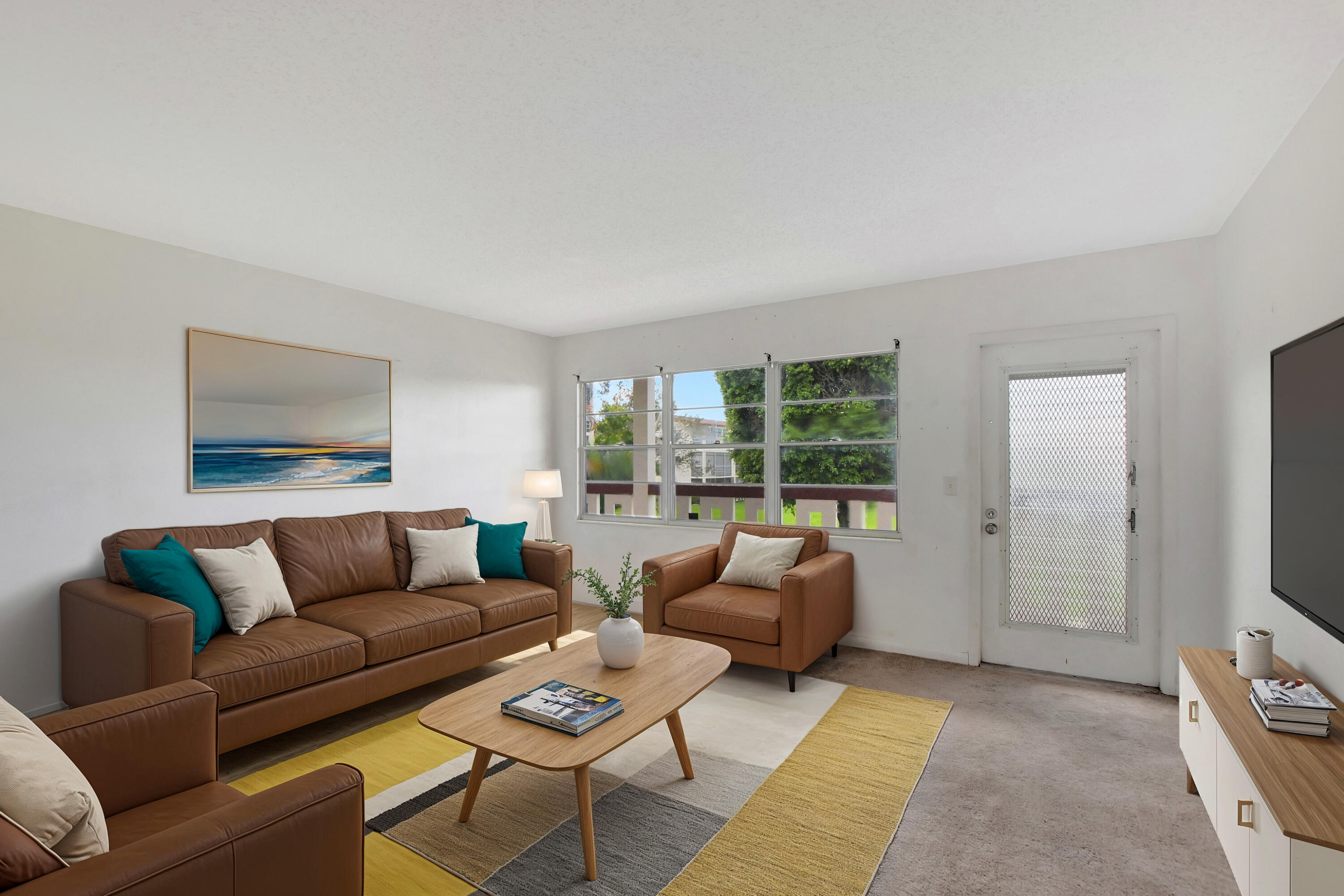 147 Brighton D, Unit D Boca Raton, FL 33434 - Photo 4 of 50 a living room with furniture and a flat screen tv