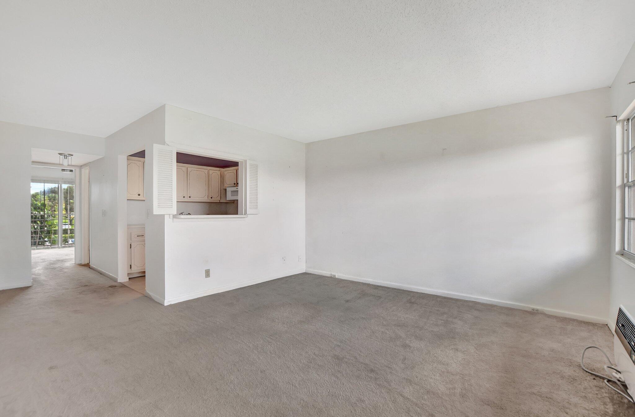 147 Brighton D, Unit D Boca Raton, FL 33434 - Photo 6 of 50 a view of empty room with window