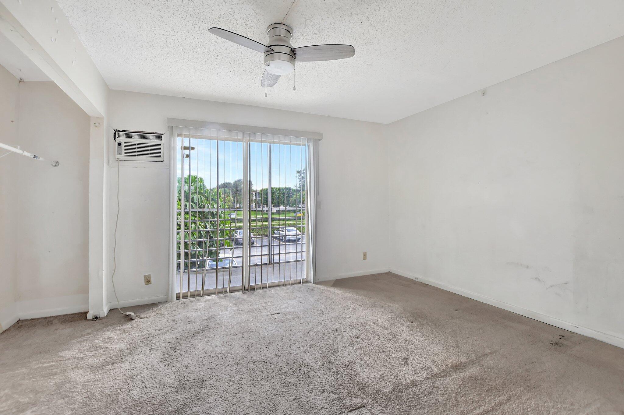 147 Brighton D, Unit D Boca Raton, FL 33434 - Photo 10 of 50 a view of an empty room with a window
