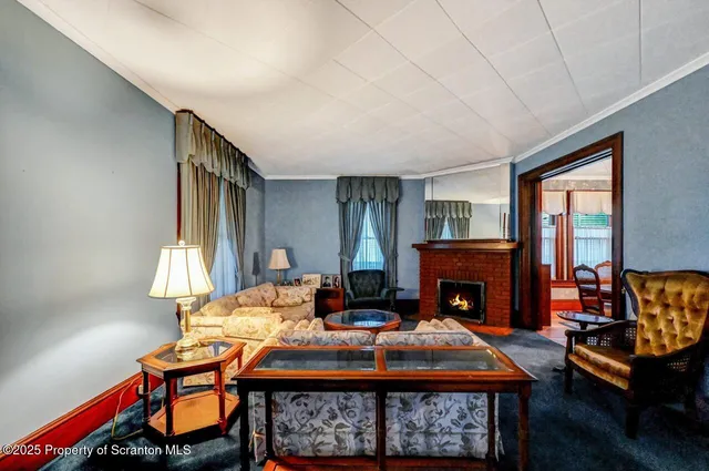 a living room with fireplace furniture and a fireplace