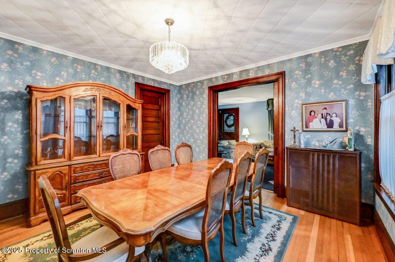 1008 Sunset Street Scranton, PA 18509 - Photo 16 of 54 a dining room with furniture a chandelier and wooden floor