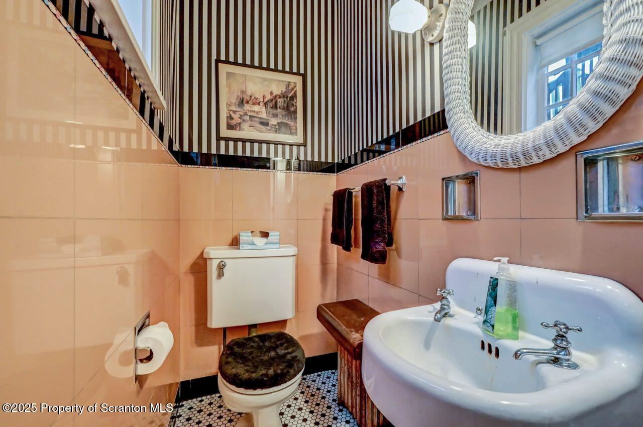 1008 Sunset Street Scranton, PA 18509 - Photo 18 of 54 a bathroom with a sink a toilet and a mirror