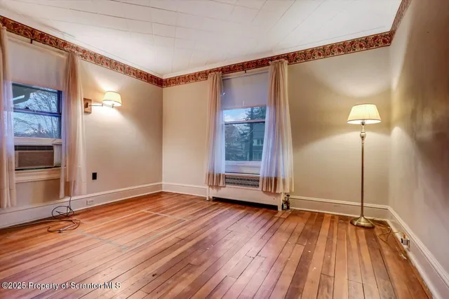 a view of a room with wooden floor
