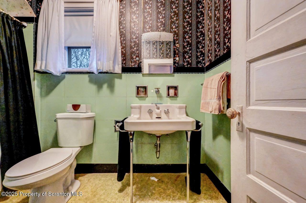 1008 Sunset Street Scranton, PA 18509 - Photo 36 of 54 a bathroom with a sink and a toilet