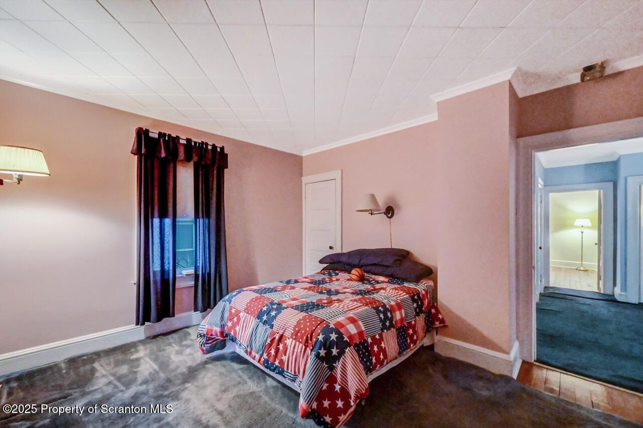 1008 Sunset Street Scranton, PA 18509 - Photo 38 of 54 a bedroom with a bed and wooden floor
