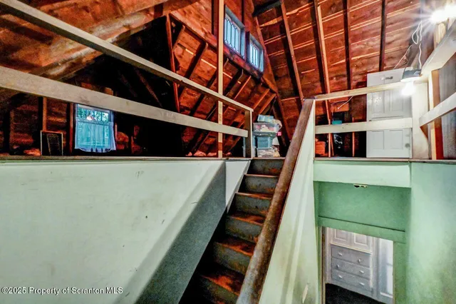 a view of an empty room with wooden walls