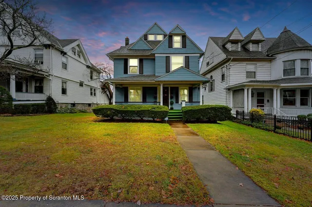 a front view of a house with a yard table and chairs