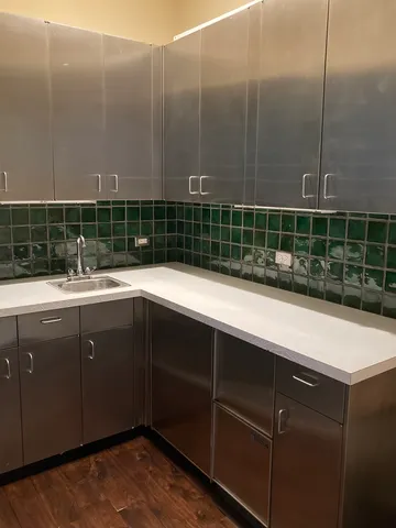 a kitchen with a sink and cabinets