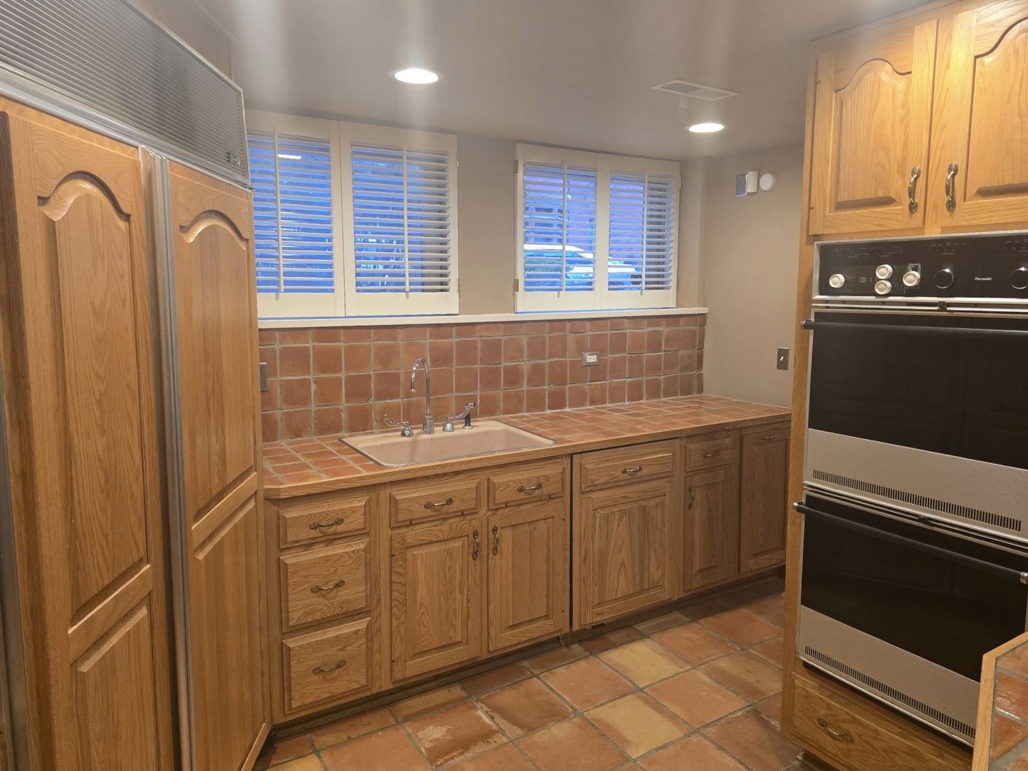 29 East Scott Street Chicago, IL 60610 - Photo 15 of 21 a kitchen with stainless steel appliances granite countertop a sink stove and refrigerator