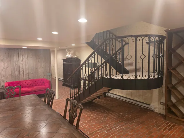 a view of staircase with white walls and a window