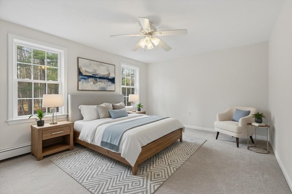 66 Box Pond Drive Bellingham, MA 02019 - Photo 13 of 41 a bedroom with a bed and a chandelier