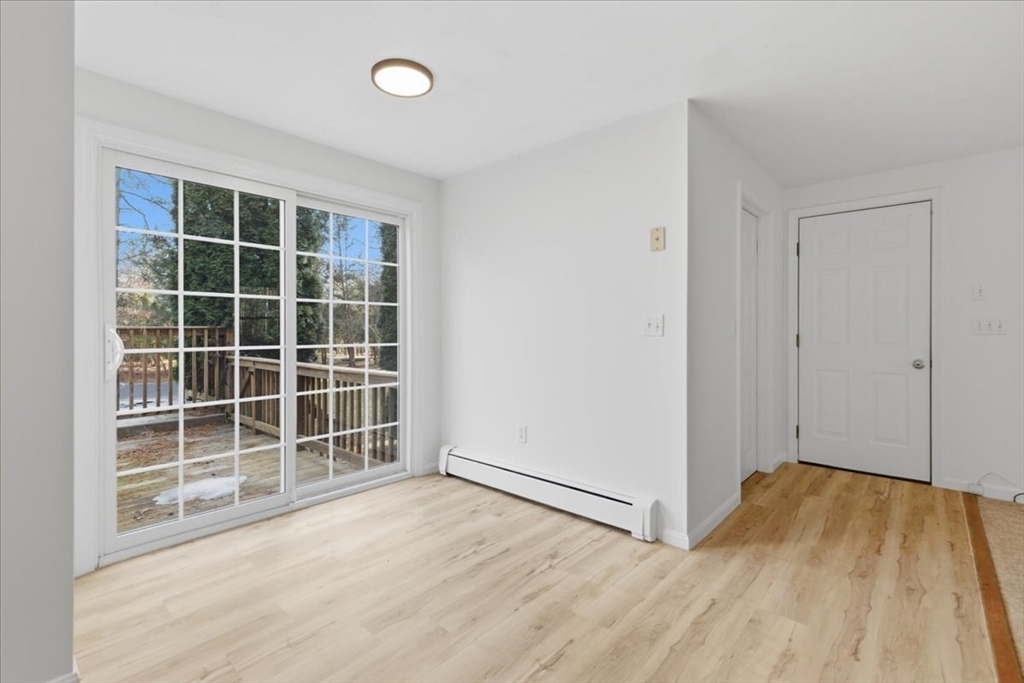 66 Box Pond Drive Bellingham, MA 02019 - Photo 19 of 41 an empty room with wooden floor and windows