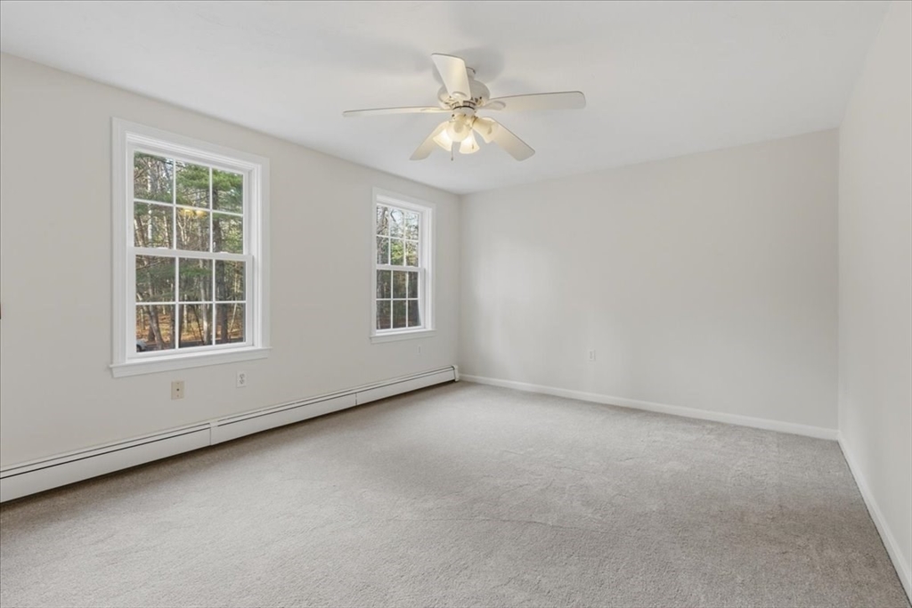 66 Box Pond Drive Bellingham, MA 02019 - Photo 23 of 41 an empty room with windows and chandelier fan
