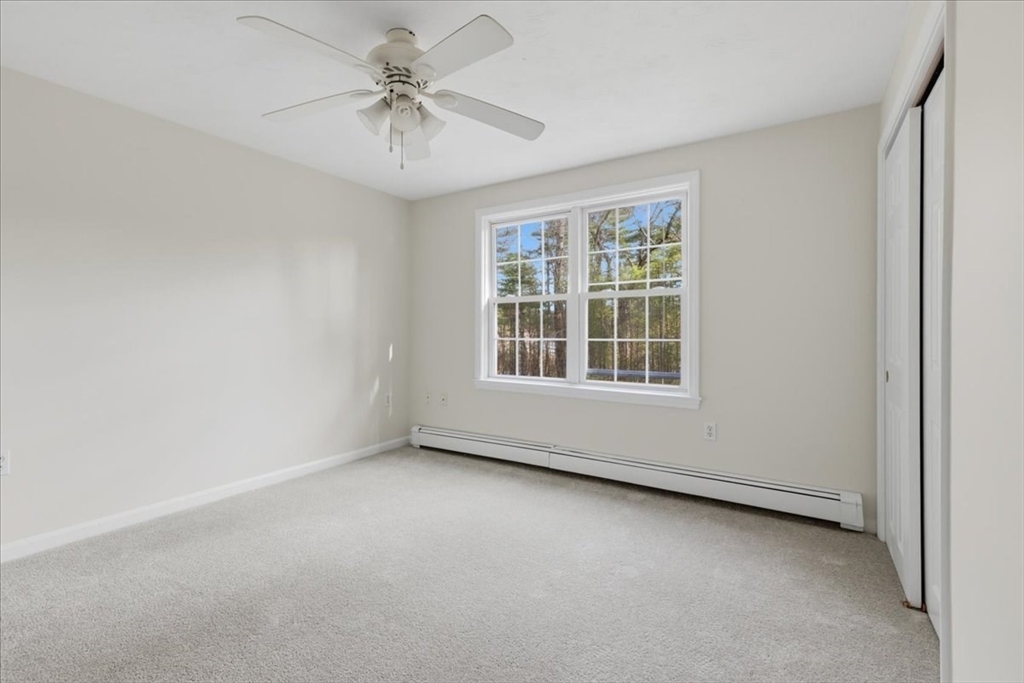 66 Box Pond Drive Bellingham, MA 02019 - Photo 24 of 41 an empty room with windows and fan