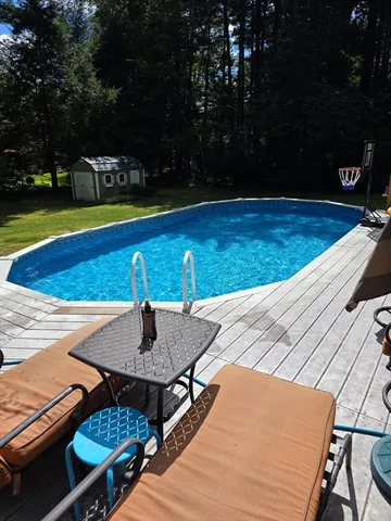 a view of a swimming pool with a yard