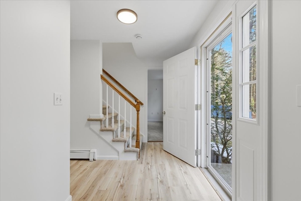 66 Box Pond Drive Bellingham, MA 02019 - Photo 3 of 41 a view of hallway with stairs and wooden floor