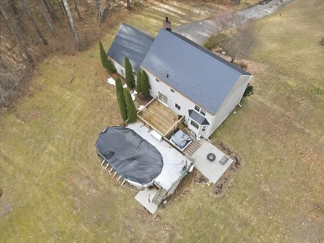 an aerial view of a house with a yard