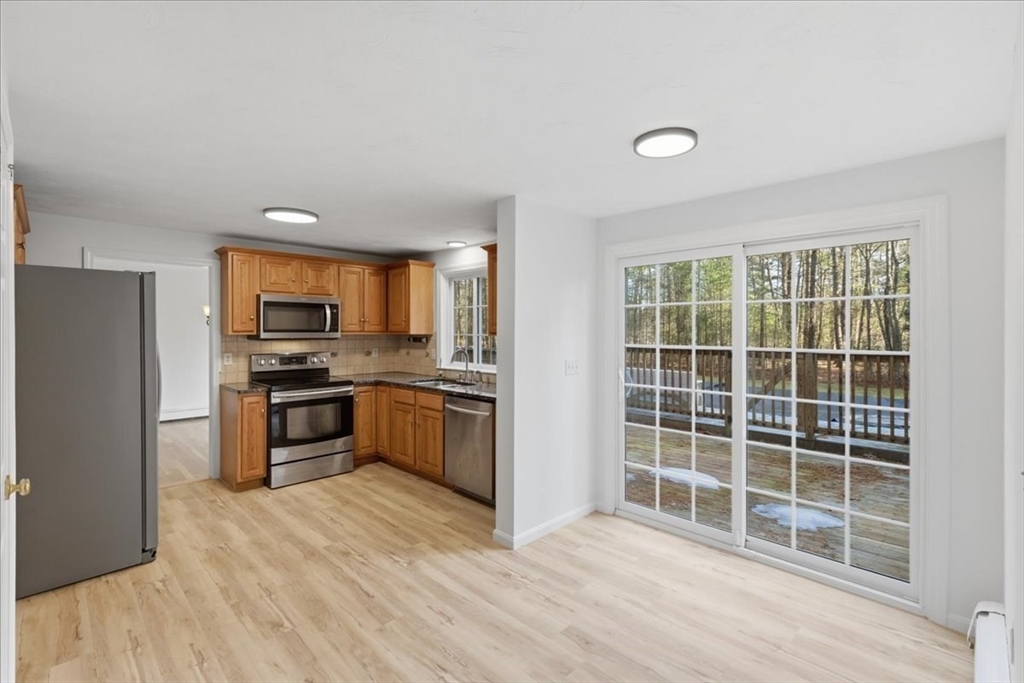 66 Box Pond Drive Bellingham, MA 02019 - Photo 8 of 41 a kitchen with stainless steel appliances a stove and a refrigerator