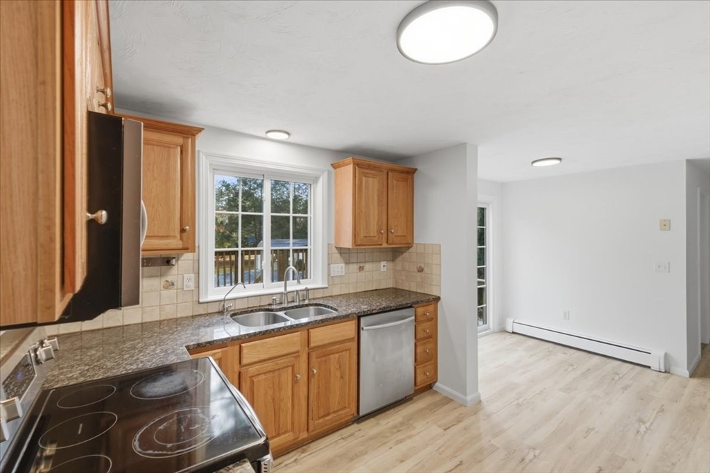 66 Box Pond Drive Bellingham, MA 02019 - Photo 9 of 41 a kitchen with a sink stove and cabinets