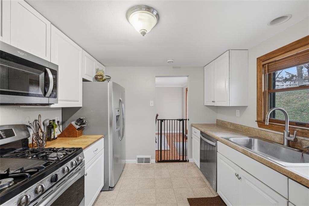 2725 Locust Drive Pittsburgh, PA 15241 - Photo 12 of 40 a kitchen with stainless steel appliances granite countertop a stove sink and cabinets