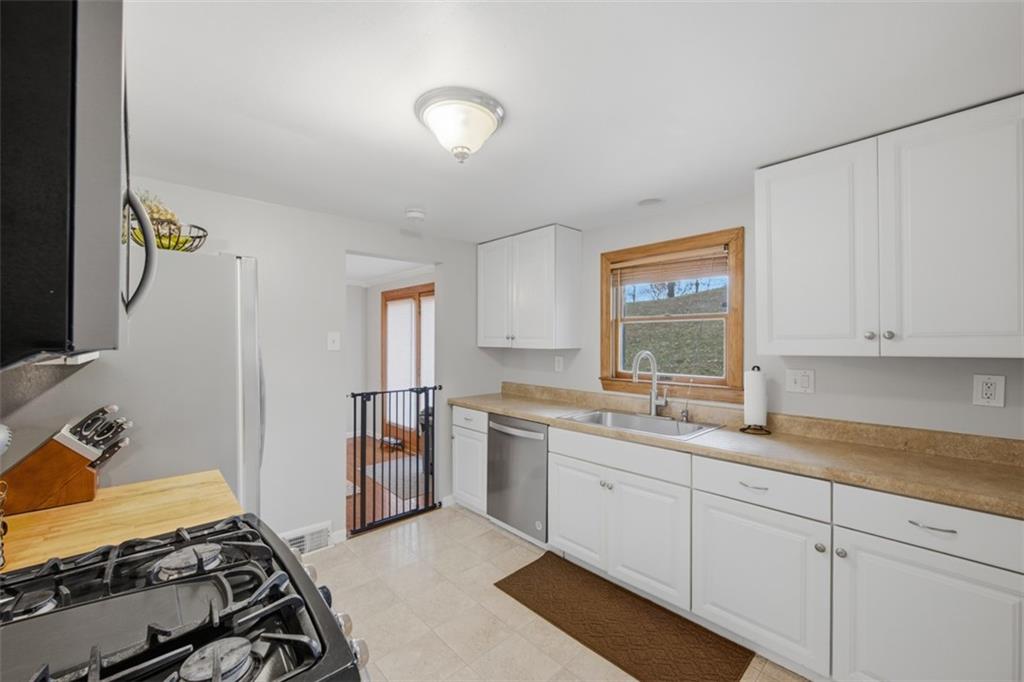2725 Locust Drive Pittsburgh, PA 15241 - Photo 13 of 40 a kitchen with a sink stove and cabinets