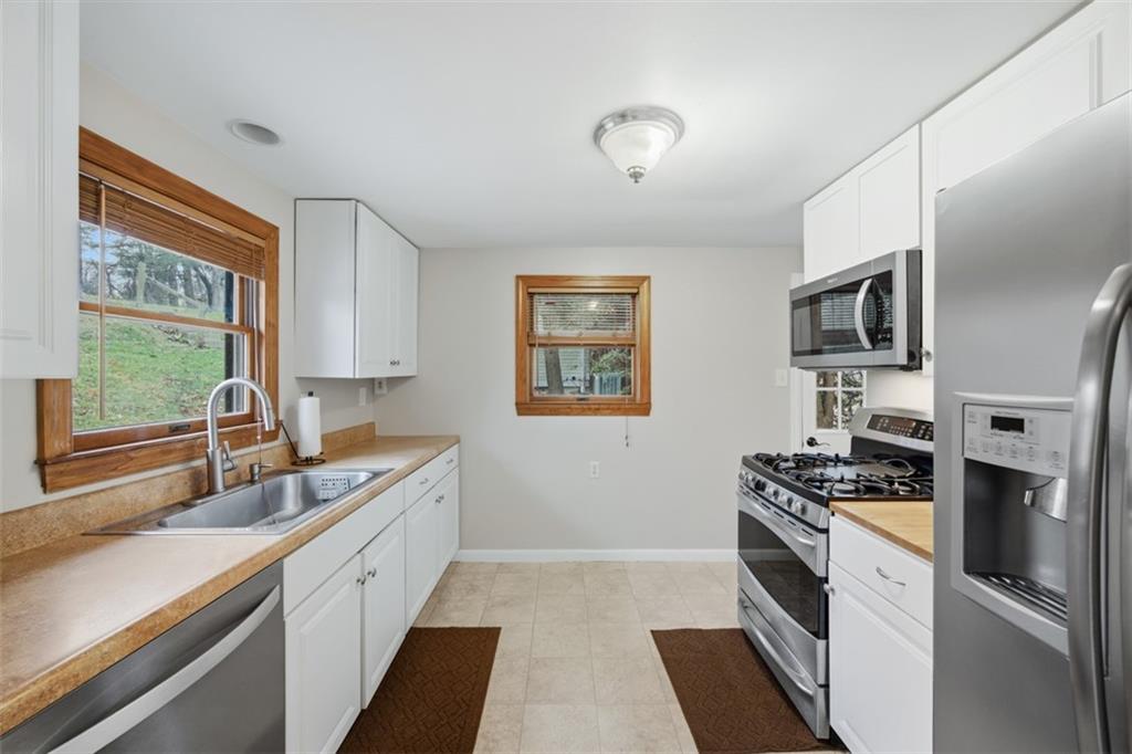 2725 Locust Drive Pittsburgh, PA 15241 - Photo 14 of 40 a kitchen with granite countertop stainless steel appliances a stove sink and refrigerator