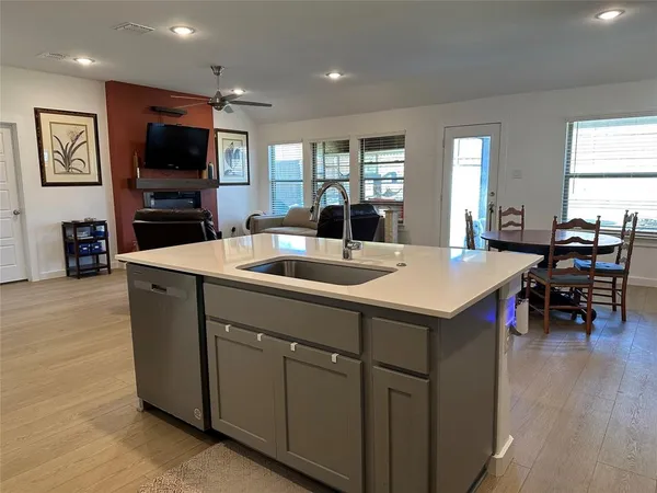 a kitchen with a sink cabinets and stainless steel appliances