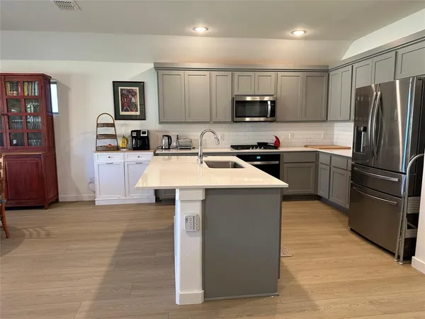 a living room with furniture windows and a wooden floor